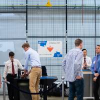 Students and guests view projects in the design bay